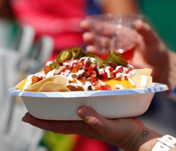 bowl of nachos with jalapenos on top bowl of nachos with jalapenos on top