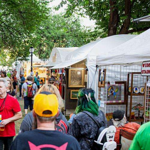 crowd of people perusing visual artists tents