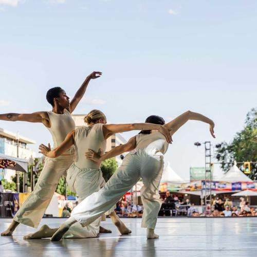 three dancers in white moving